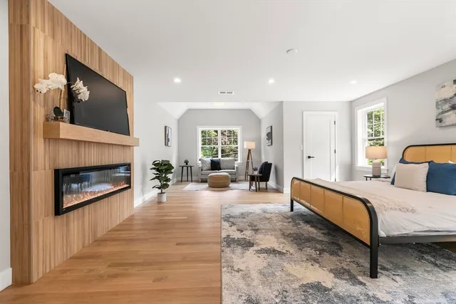 a spacious bedroom with a bed and a fireplace