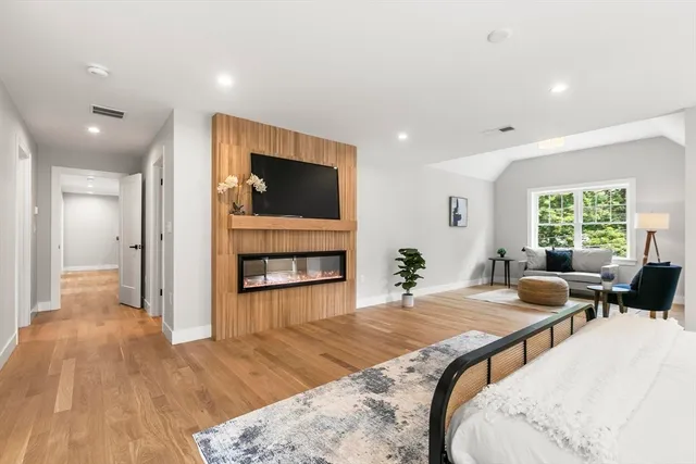 a living room with fireplace furniture and a flat screen tv