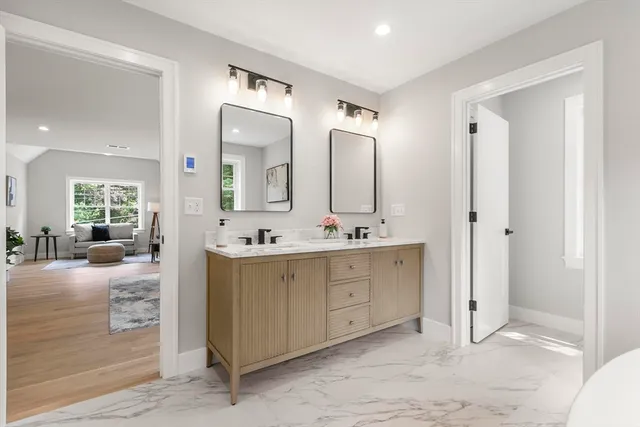 a spacious bathroom with a double vanity sink mirror and double