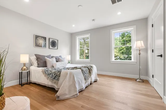 a spacious bedroom with a bed and a window
