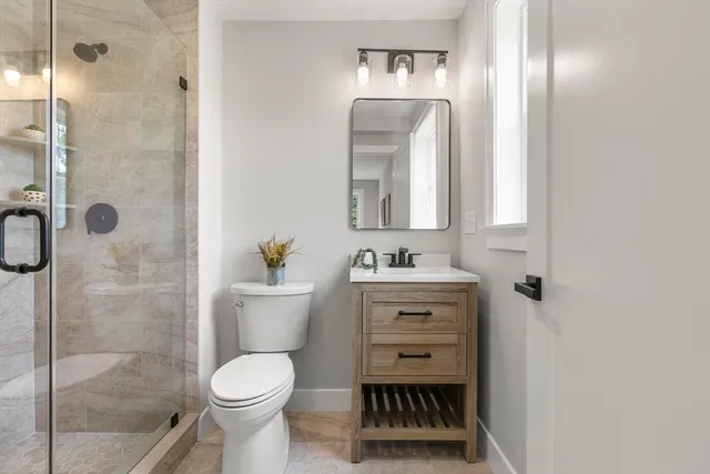 a bathroom with a toilet sink and shower