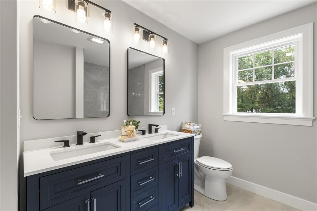 29 Beaverbrook Road Burlington, MA 01803 - Photo 31 of 42 a bathroom with a double vanity sink toilet and a mirror