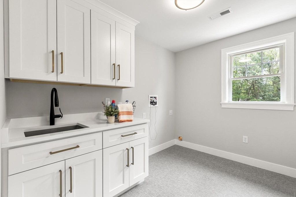 29 Beaverbrook Road Burlington, MA 01803 - Photo 32 of 42 a kitchen with white cabinets and window