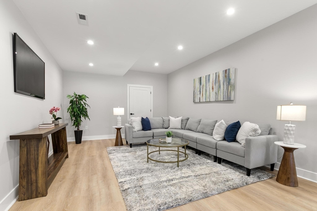 29 Beaverbrook Road Burlington, MA 01803 - Photo 35 of 42 a living room with furniture a flat screen tv and a potted plant
