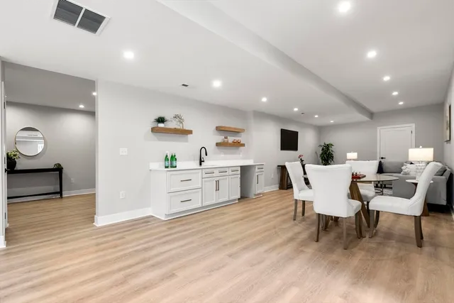a view of a dining room with furniture and wooden floor