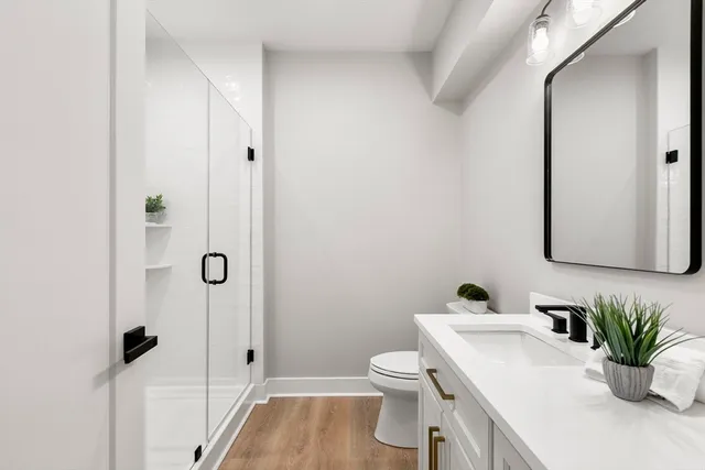 a bathroom with a sink toilet and shower