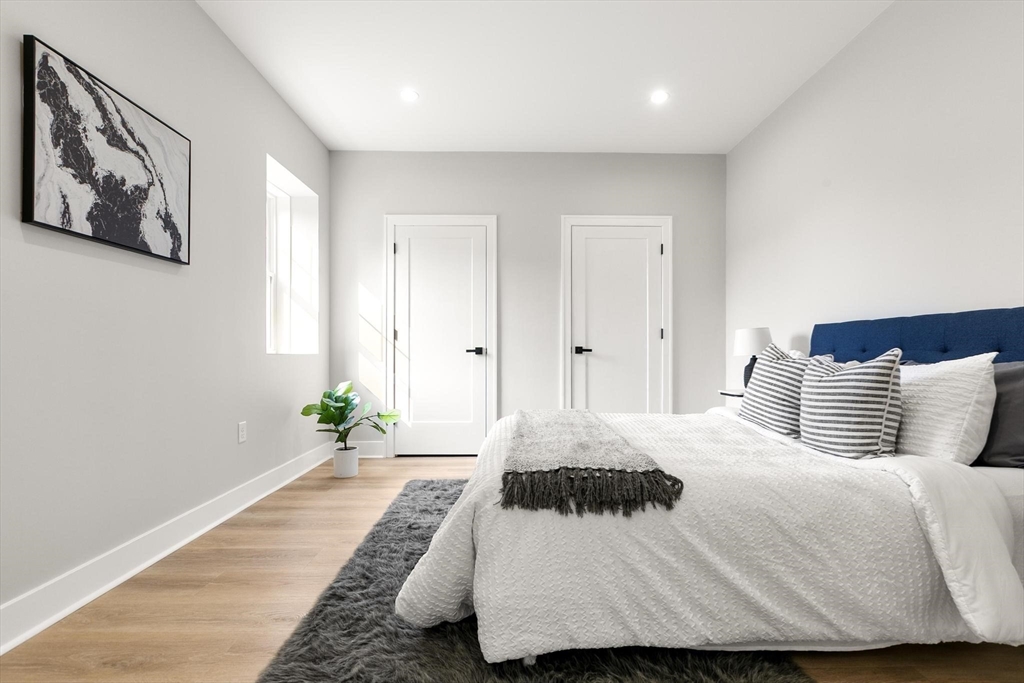 29 Beaverbrook Road Burlington, MA 01803 - Photo 38 of 42 a bedroom with a large bed and a potted plant