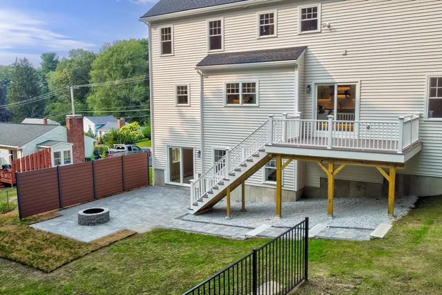 a view of a house with backyard and sitting area