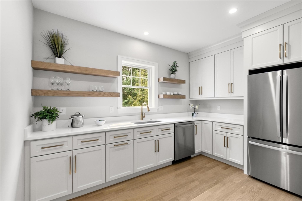 29 Beaverbrook Road Burlington, MA 01803 - Photo 9 of 42 a kitchen with a sink white cabinets and white appliances
