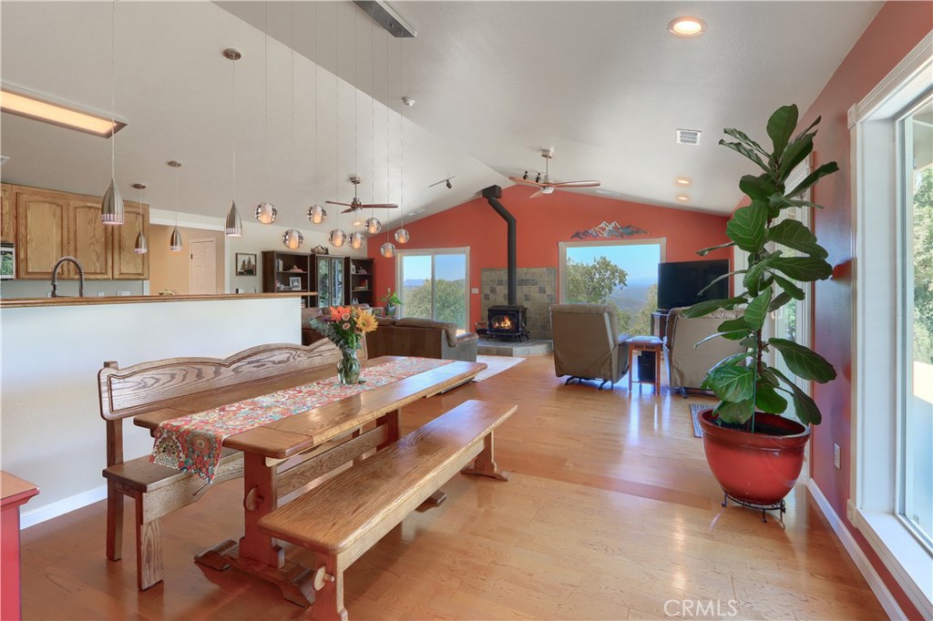 6097 Sherlock Road Midpines, CA 95345 - Photo 11 of 63 a dining room with furniture a potted plant and a large window