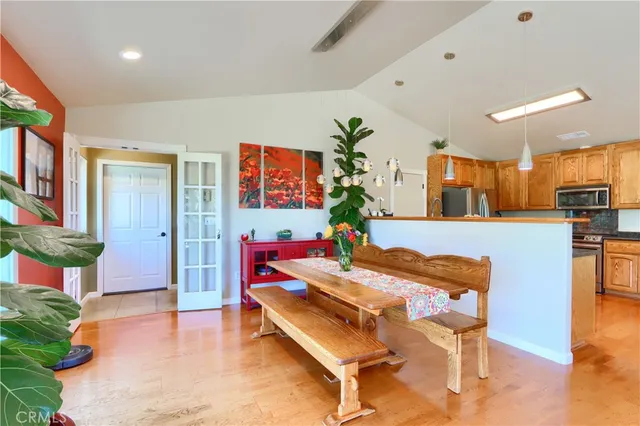 a kitchen with granite countertop a refrigerator stove and cabinets
