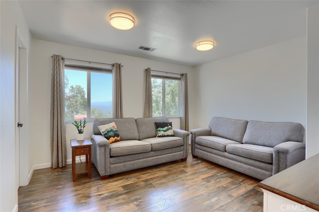 6097 Sherlock Road Midpines, CA 95345 - Photo 18 of 63 a living room with furniture and a wooden floor