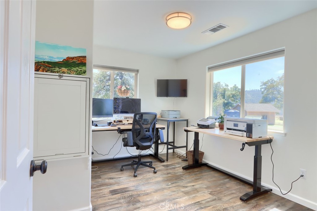 6097 Sherlock Road Midpines, CA 95345 - Photo 22 of 63 a view of a workspace with furniture and a window