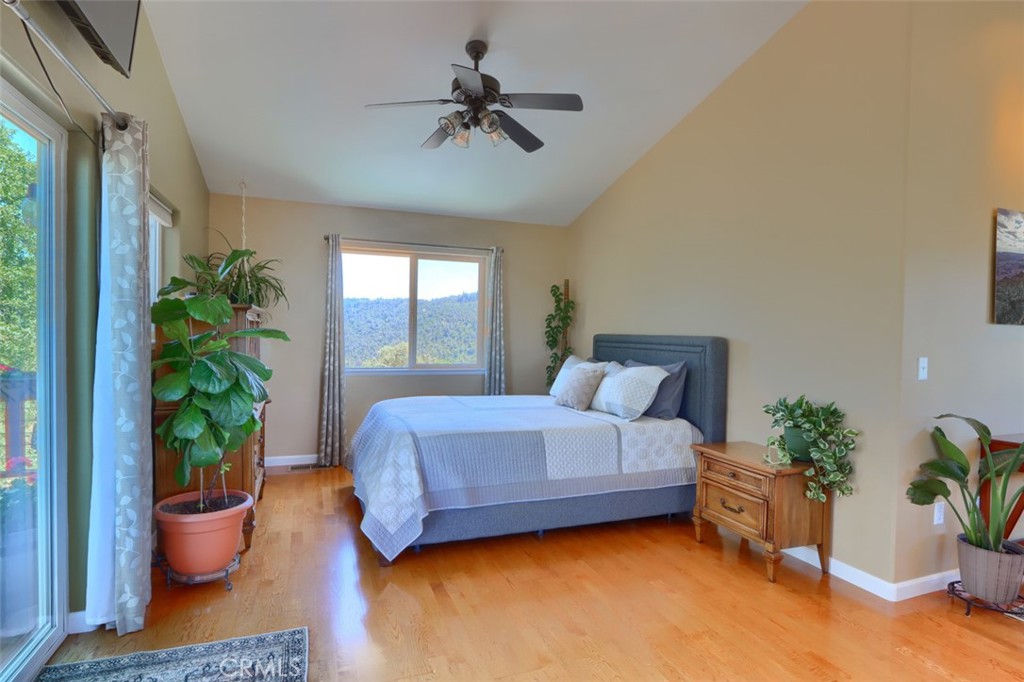 6097 Sherlock Road Midpines, CA 95345 - Photo 28 of 63 a bedroom with a bed potted plant and a window