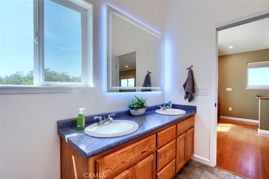 6097 Sherlock Road Midpines, CA 95345 - Photo 31 of 63 a bathroom with sink granite and a mirror