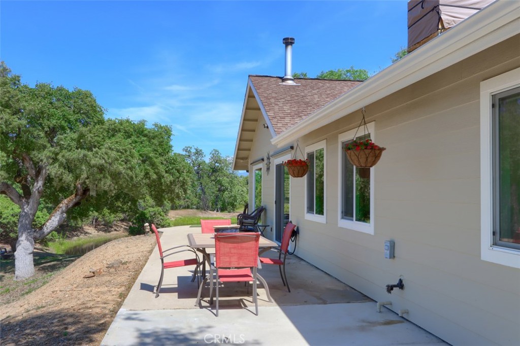 6097 Sherlock Road Midpines, CA 95345 - Photo 37 of 63 a backyard of a house with table and chairs