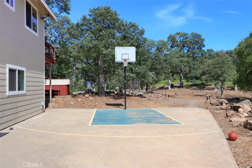 6097 Sherlock Road Midpines, CA 95345 - Photo 48 of 63 a swimming pool with potted plants and large trees