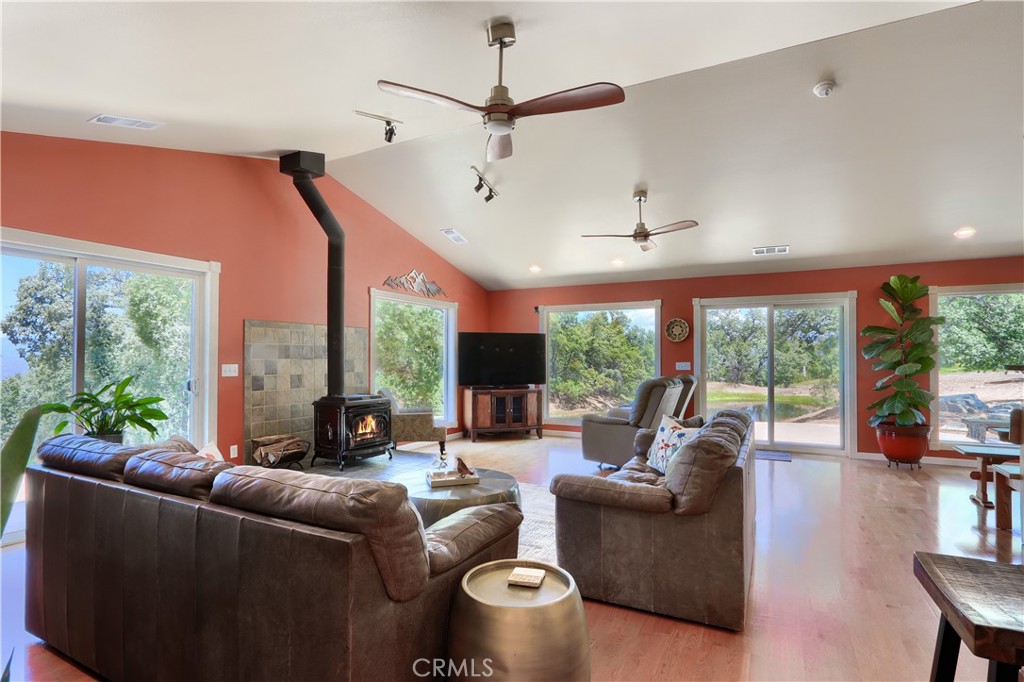 6097 Sherlock Road Midpines, CA 95345 - Photo 5 of 63 a living room with furniture a ceiling fan and a large window