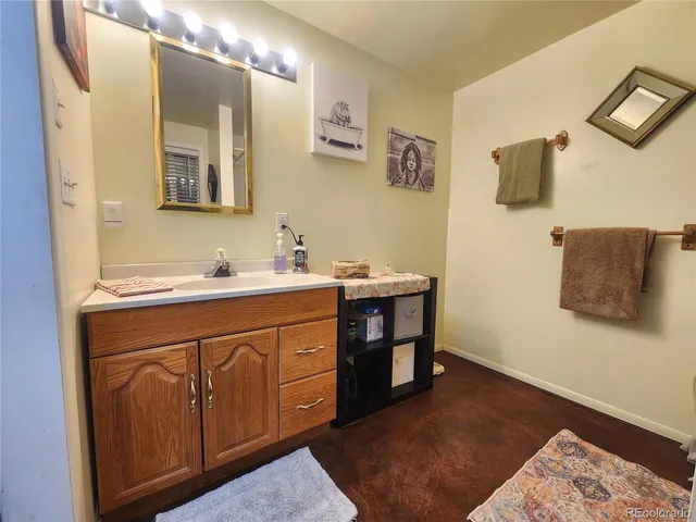 a spacious bathroom with a sink and a mirror