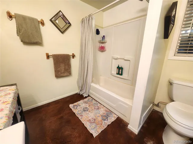 a bathroom with a shower and a toilet