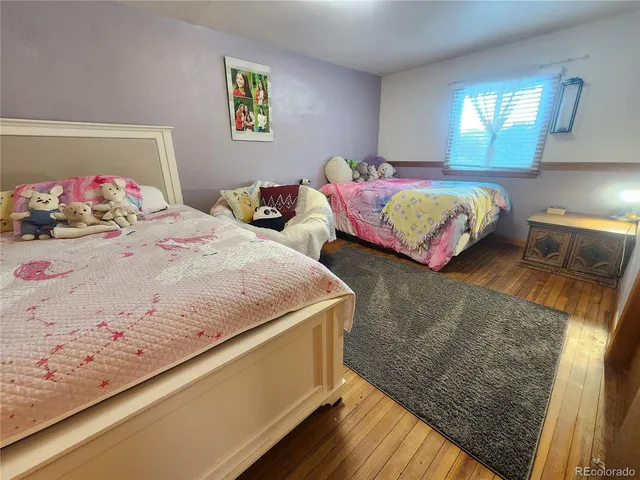 a bedroom with two beds and a couch