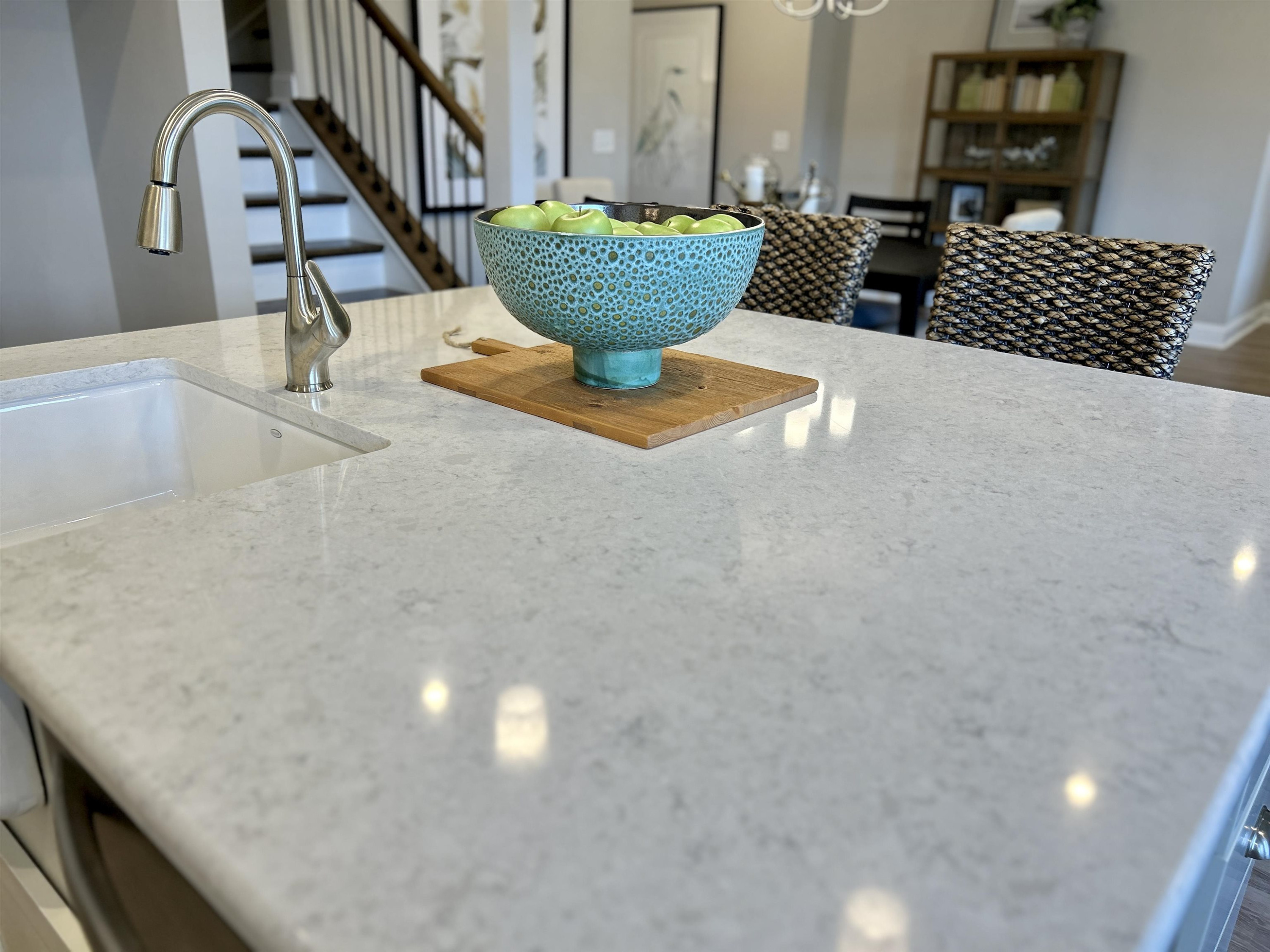 a view of staircase with open kitchen view
