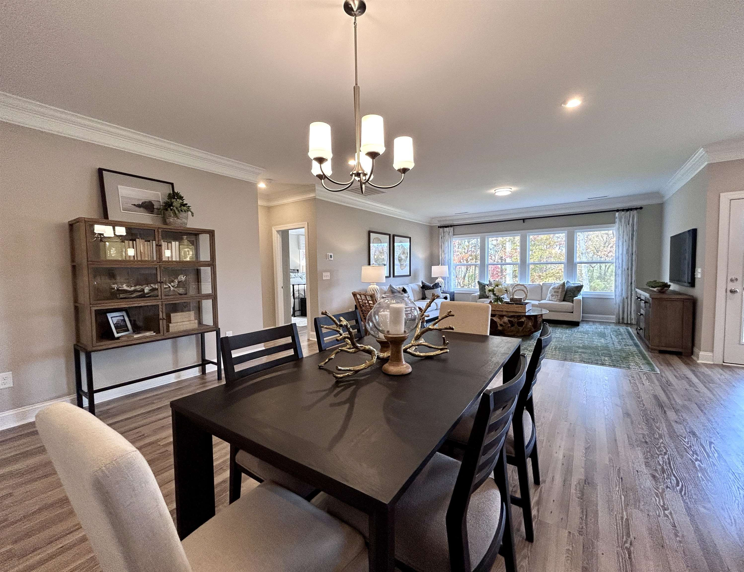 204 Kavanaugh Road Wake Forest, NC 27587 - Photo 15 of 53 a view of a dining room and livingroom with furniture wooden floor a rug a painting and a chandelier