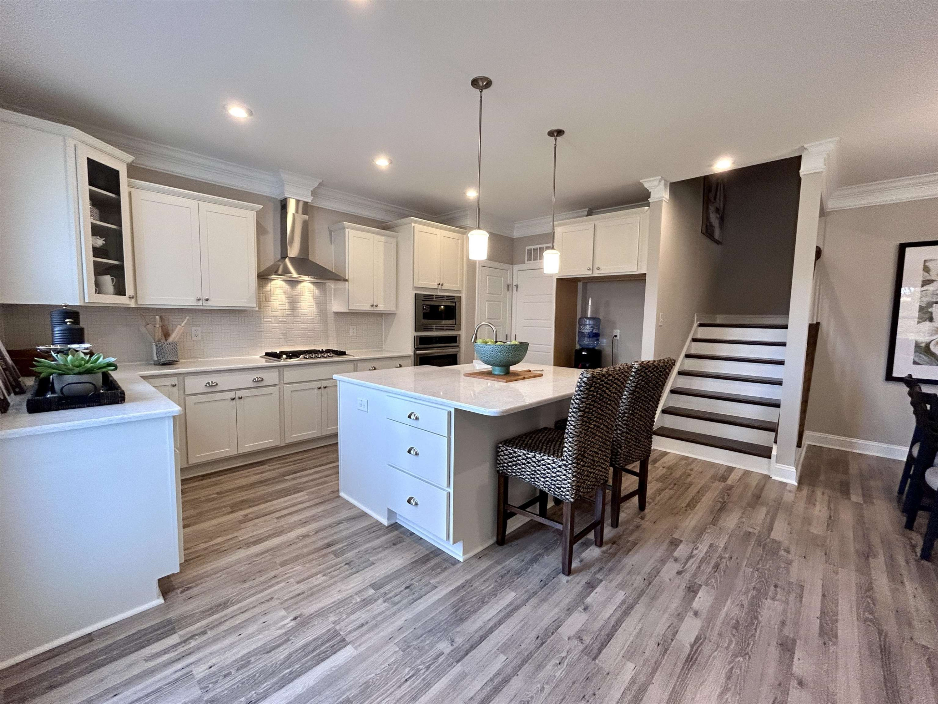 204 Kavanaugh Road Wake Forest, NC 27587 - Photo 23 of 53 a kitchen with a refrigerator a stove top oven a sink dishwasher and white cabinets with wooden floor