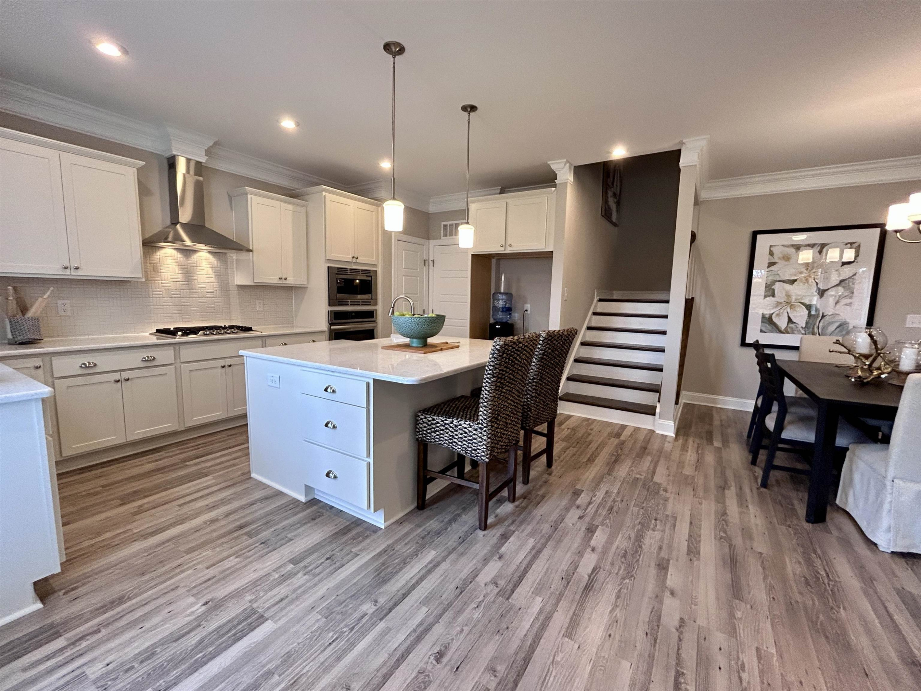 204 Kavanaugh Road Wake Forest, NC 27587 - Photo 24 of 53 a kitchen with stainless steel appliances a dining table chairs microwave and sink