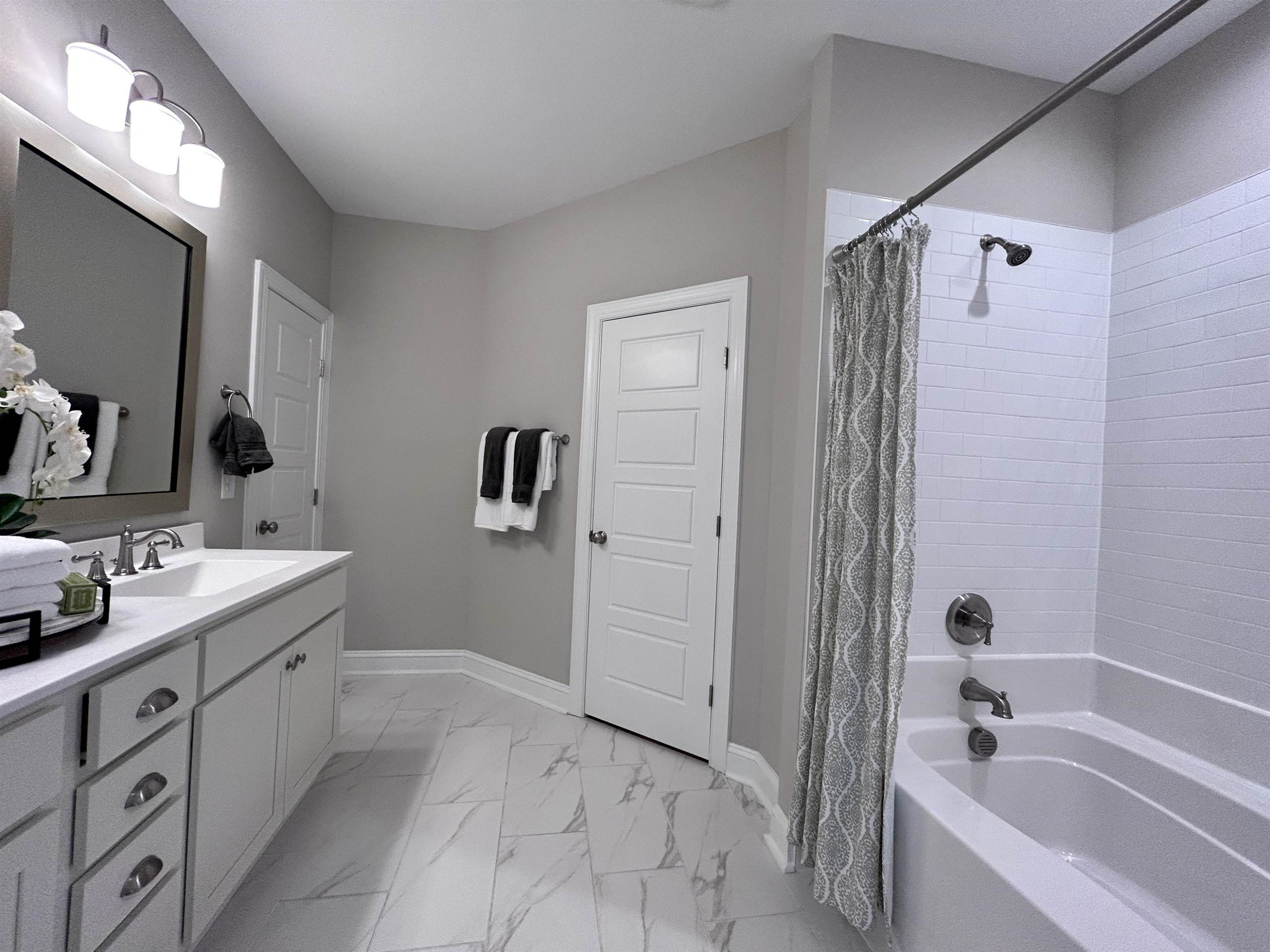 204 Kavanaugh Road Wake Forest, NC 27587 - Photo 43 of 53 a bathroom with a tub sink and mirror