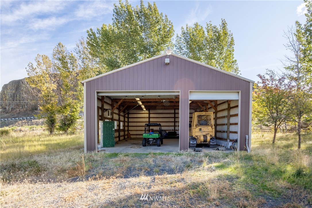 700 Coulee Meadows Road Waterville, WA 98858 - Photo 12 of 25 a view of a house with a yard fire pit and a large tree