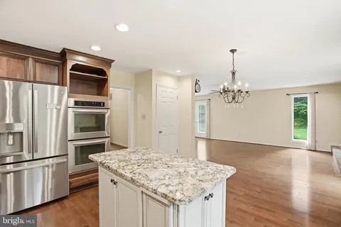 a kitchen with stainless steel appliances granite countertop a sink and refrigerator
