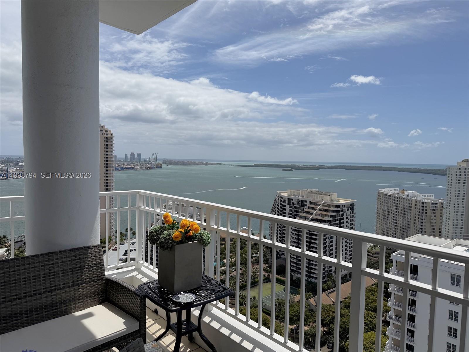801 Brickell Key Boulevard, Unit 3207 Miami, FL 33131 - Photo 1 of 67 a terrace with a bench
