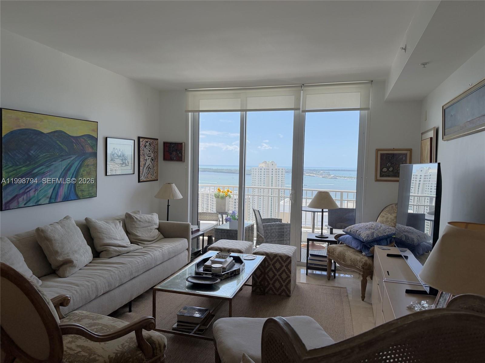 801 Brickell Key Boulevard, Unit 3207 Miami, FL 33131 - Photo 16 of 67 a living room with furniture floor and a large window