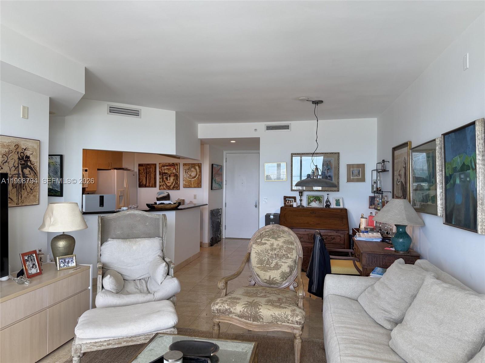 801 Brickell Key Boulevard, Unit 3207 Miami, FL 33131 - Photo 17 of 67 a living room with furniture and a large window