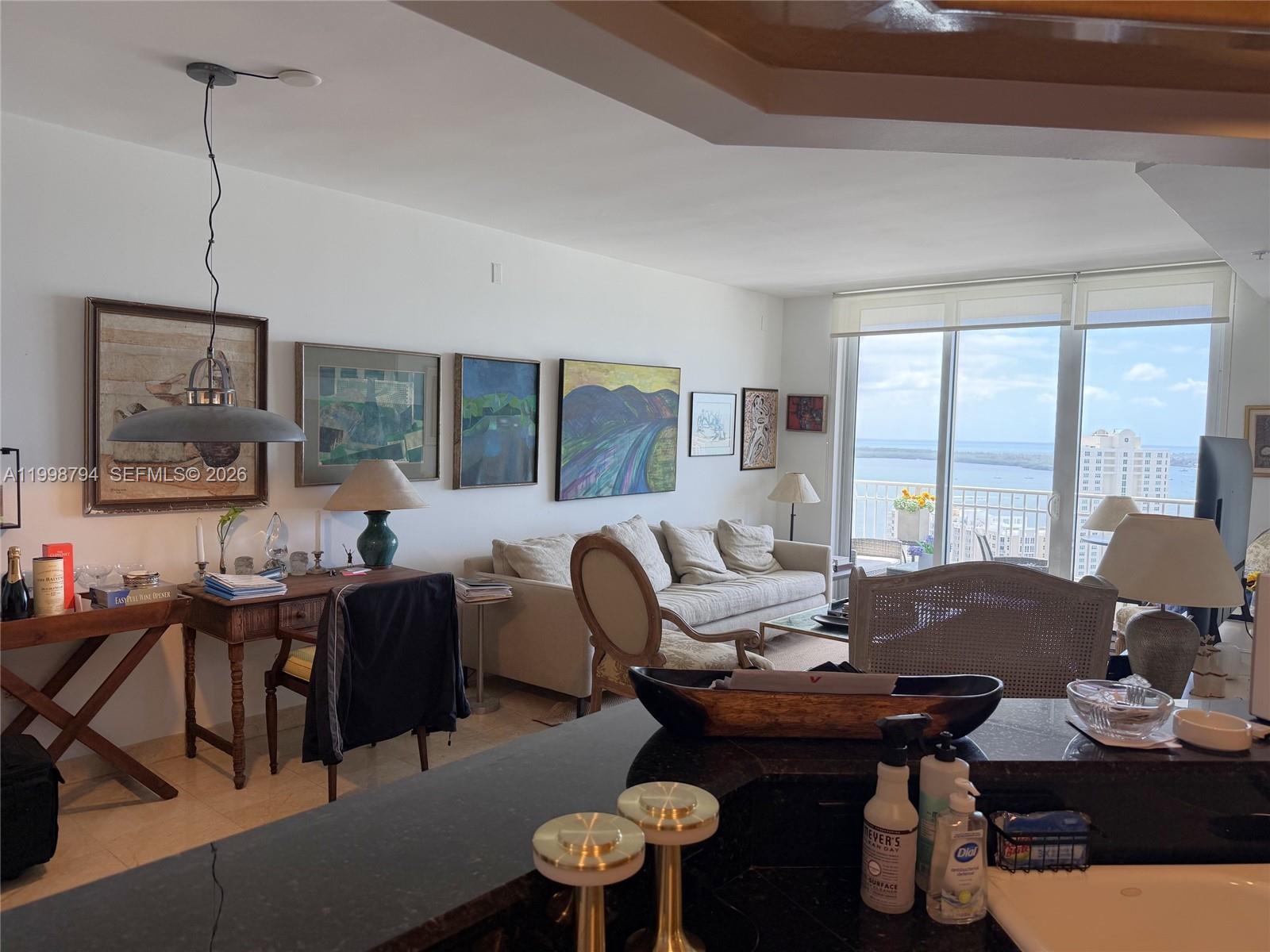 801 Brickell Key Boulevard, Unit 3207 Miami, FL 33131 - Photo 21 of 67 a living room with furniture and floor to ceiling windows