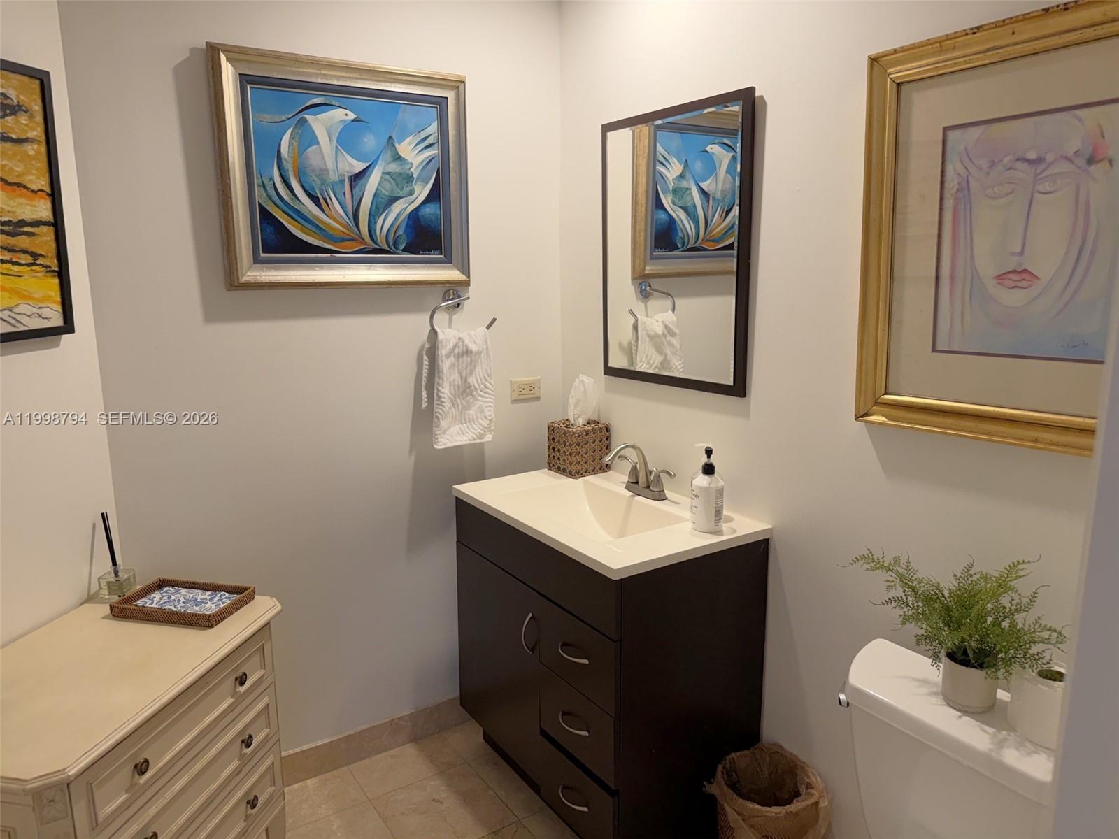 801 Brickell Key Boulevard, Unit 3207 Miami, FL 33131 - Photo 22 of 67 a bathroom with a toilet a sink and mirror