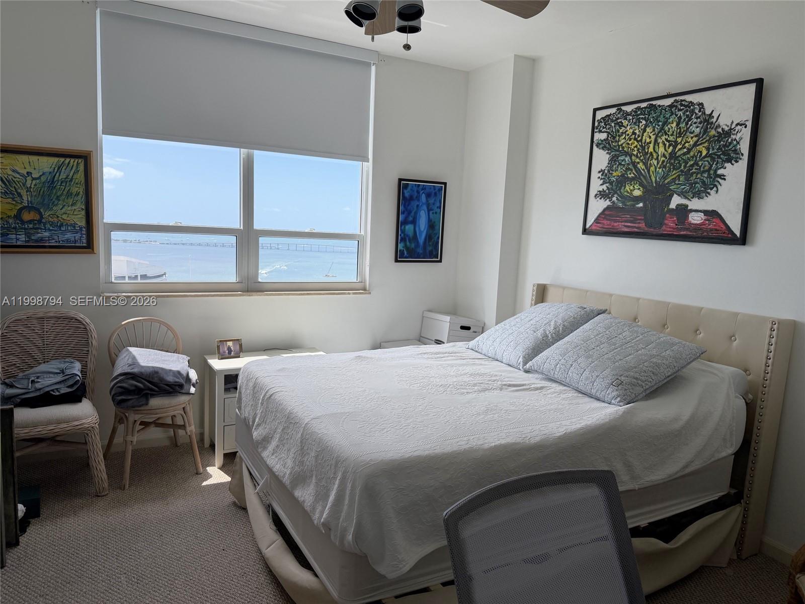 801 Brickell Key Boulevard, Unit 3207 Miami, FL 33131 - Photo 25 of 67 a bedroom with a bed and a window