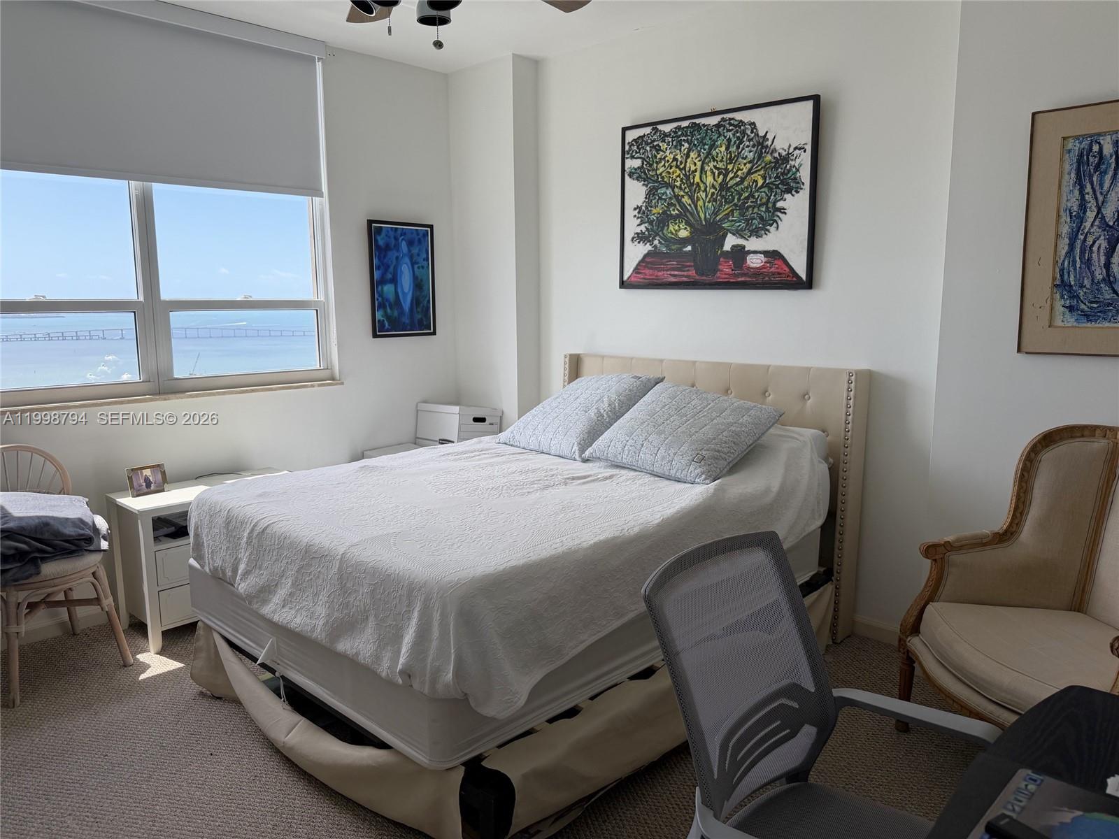 801 Brickell Key Boulevard, Unit 3207 Miami, FL 33131 - Photo 27 of 67 a bedroom with a bed and a chair