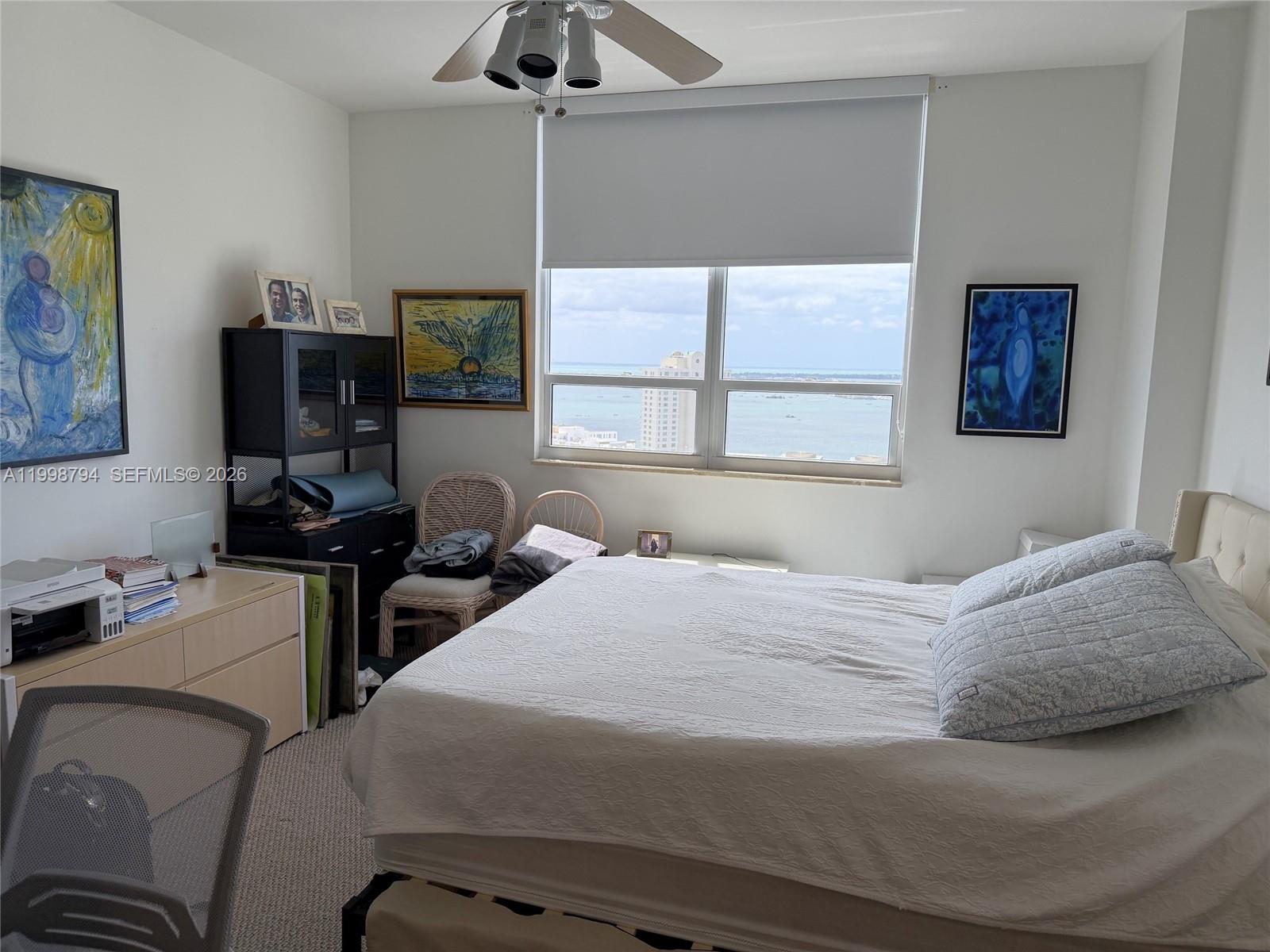 801 Brickell Key Boulevard, Unit 3207 Miami, FL 33131 - Photo 29 of 67 a bedroom with a bed and wooden floor