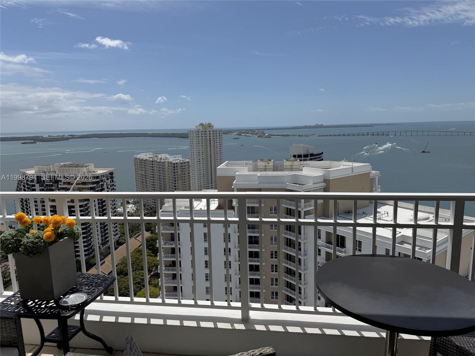 801 Brickell Key Boulevard, Unit 3207 Miami, FL 33131 - Photo 3 of 67 a view of a balcony with chairs