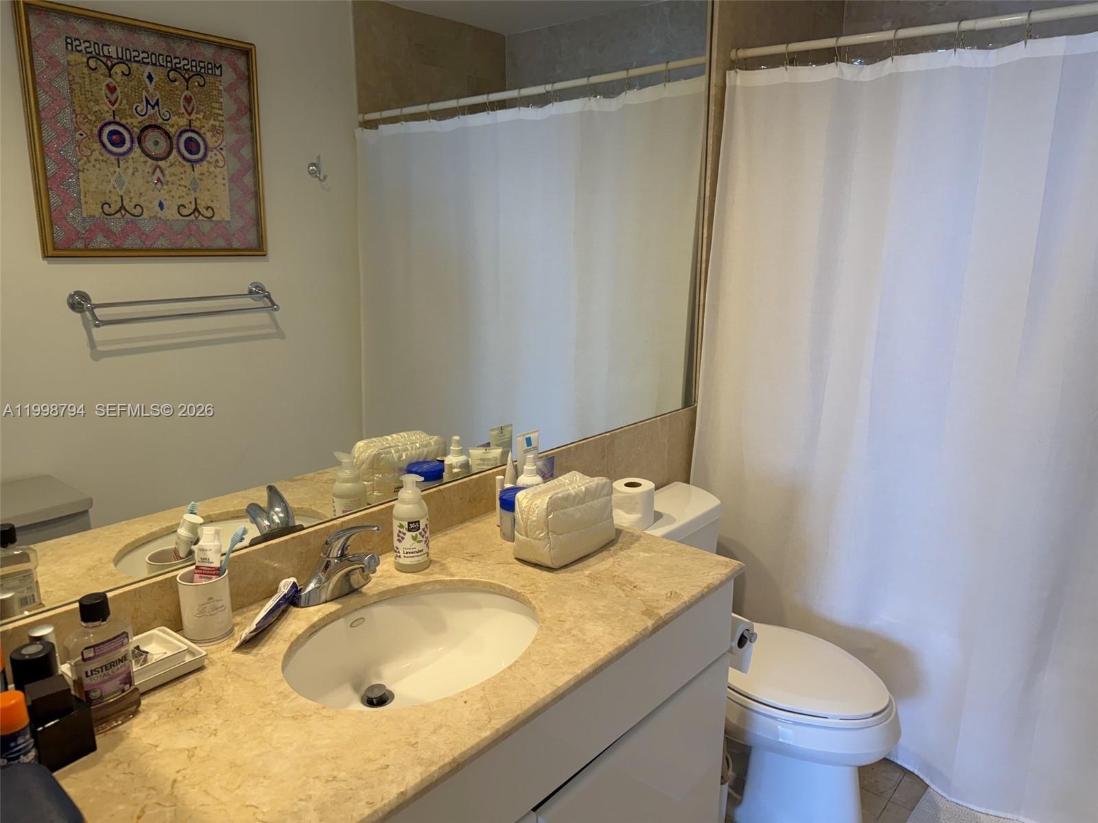 801 Brickell Key Boulevard, Unit 3207 Miami, FL 33131 - Photo 31 of 67 a bathroom with a sink and a mirror