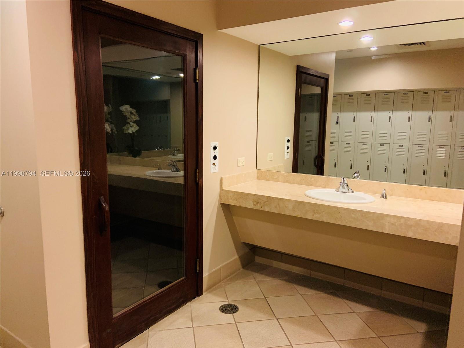 801 Brickell Key Boulevard, Unit 3207 Miami, FL 33131 - Photo 47 of 67 a bathroom with a bathtub and a sink