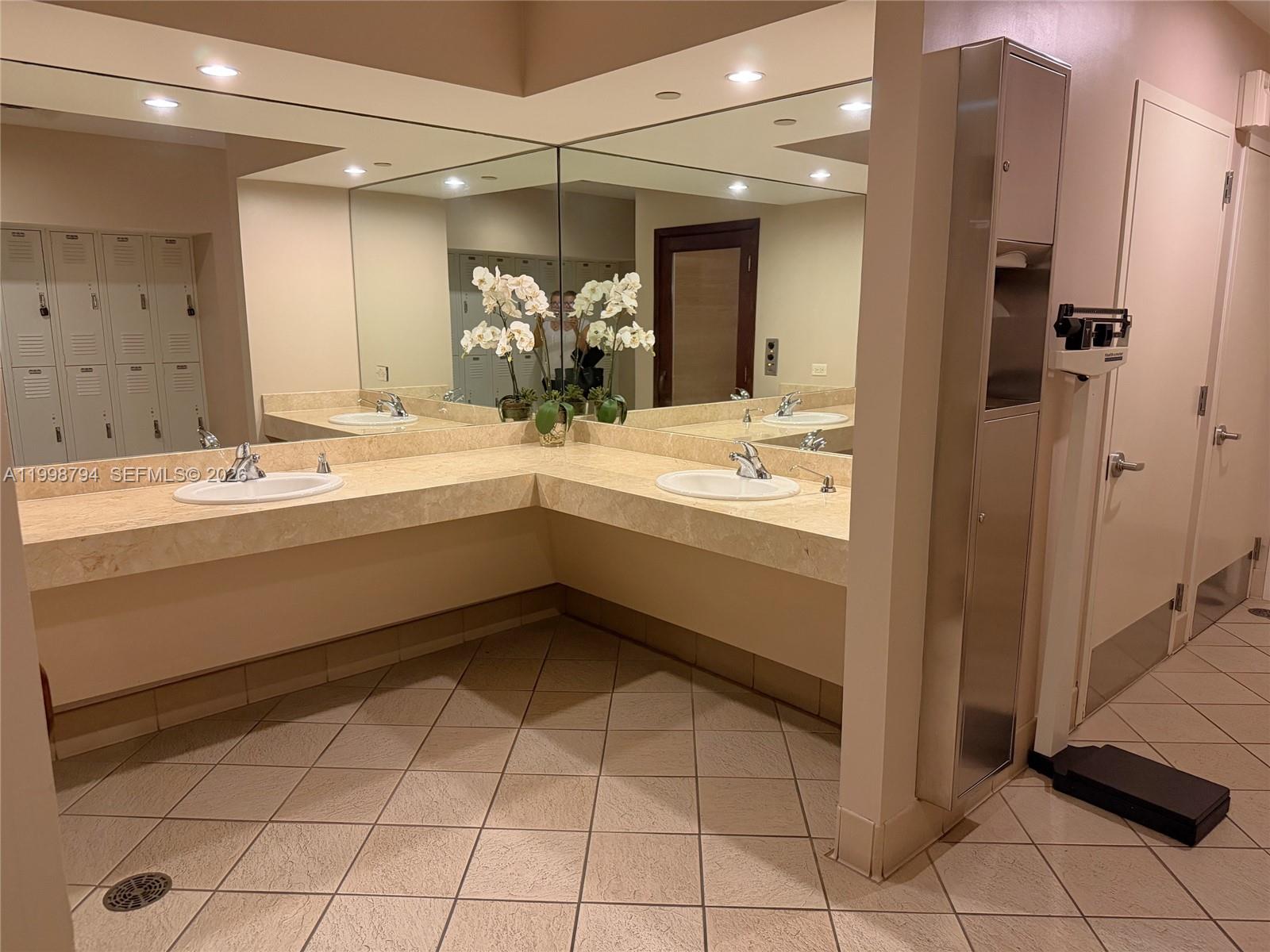 801 Brickell Key Boulevard, Unit 3207 Miami, FL 33131 - Photo 50 of 67 a bathroom with a sink a mirror and a shower