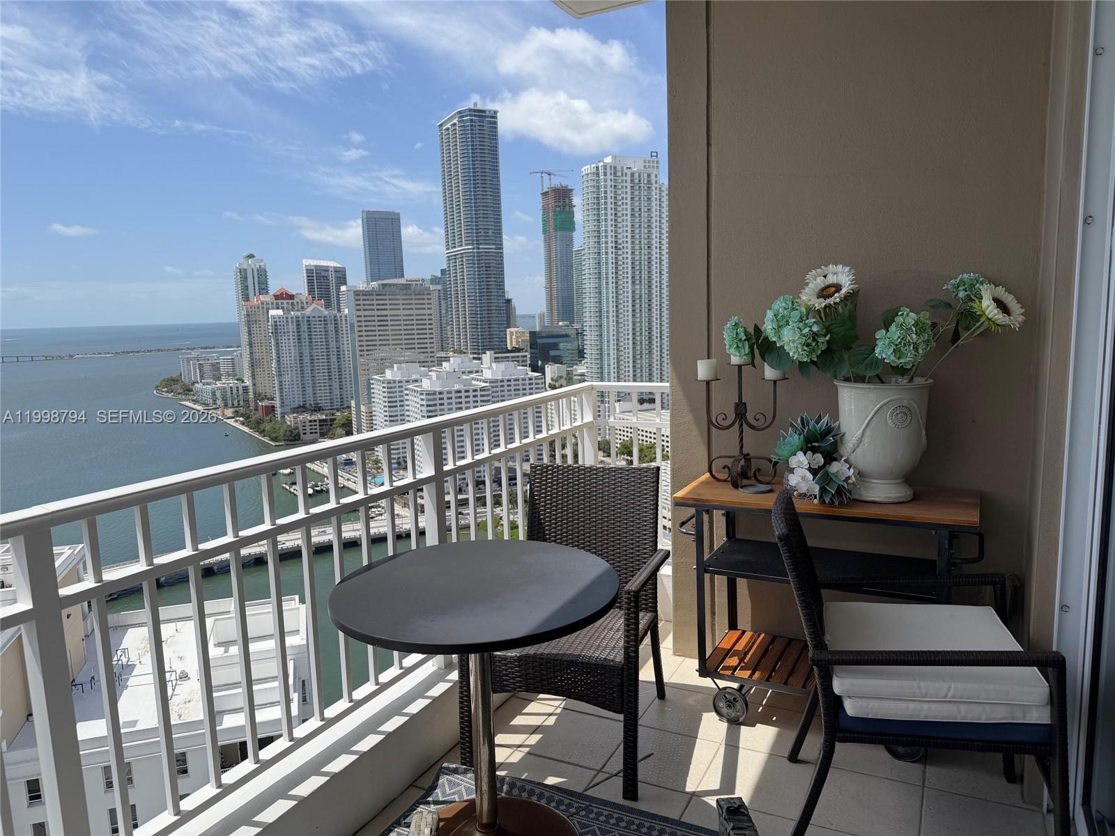 801 Brickell Key Boulevard, Unit 3207 Miami, FL 33131 - Photo 5 of 67 a view of a balcony with furniture
