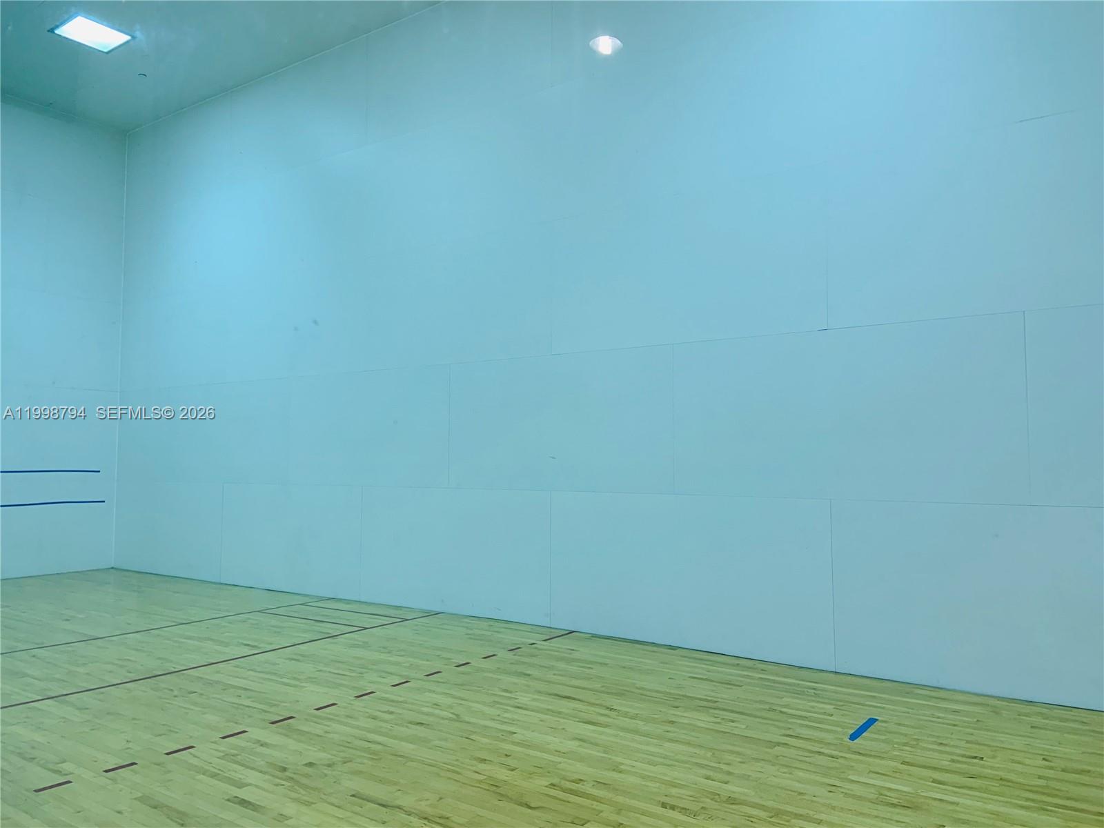 801 Brickell Key Boulevard, Unit 3207 Miami, FL 33131 - Photo 54 of 67 a view of an empty room with wooden floor