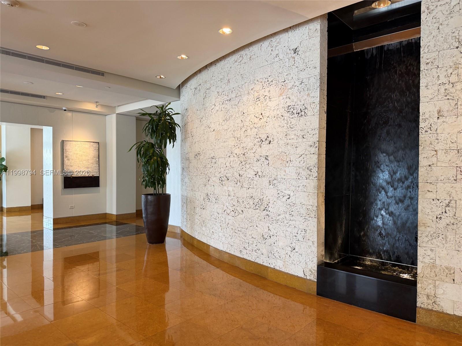 801 Brickell Key Boulevard, Unit 3207 Miami, FL 33131 - Photo 63 of 67 a view of livingroom with hardwood floor and a ceiling fan