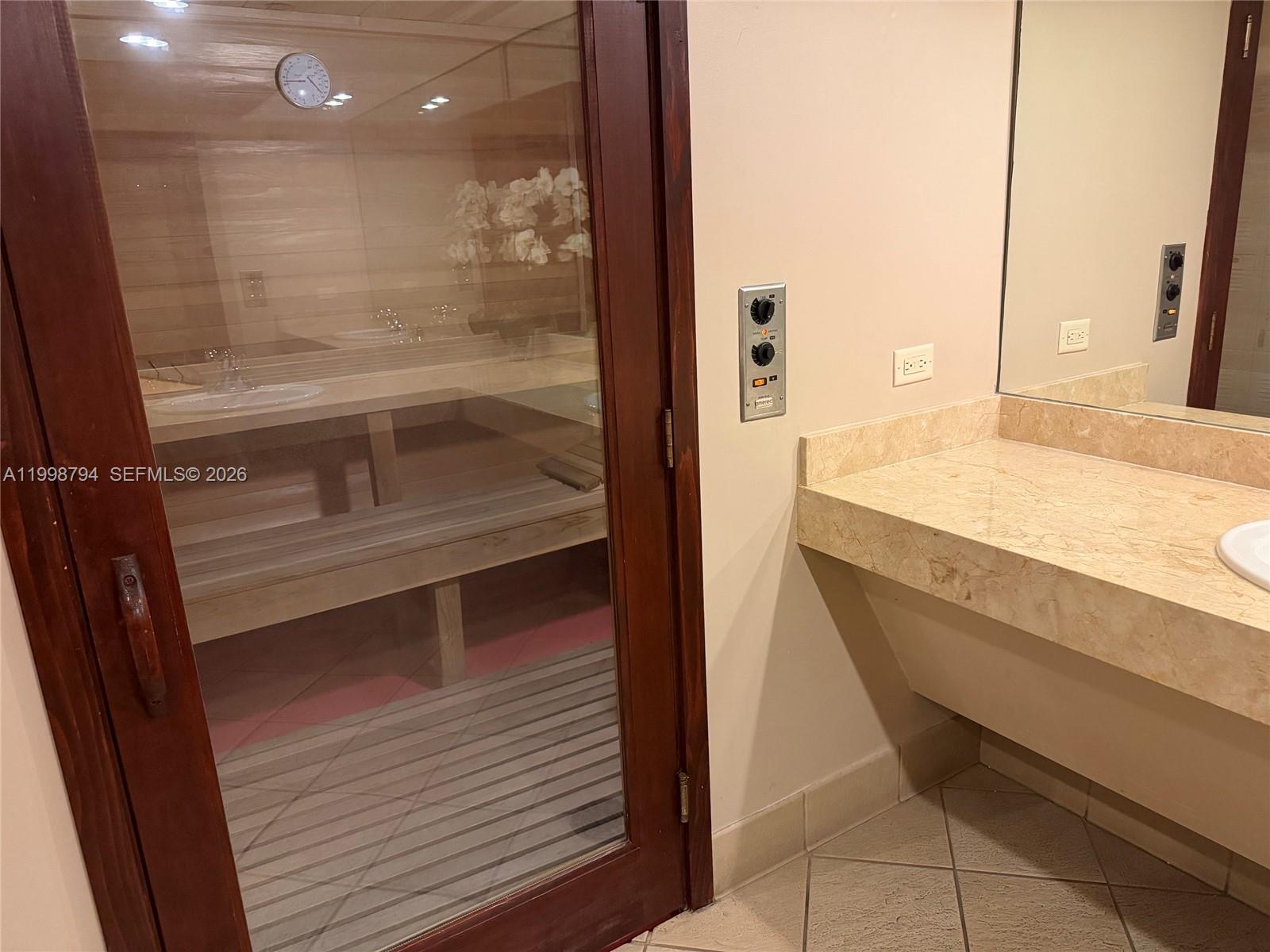 801 Brickell Key Boulevard, Unit 3207 Miami, FL 33131 - Photo 64 of 67 a bathroom with a bathtub and a sink