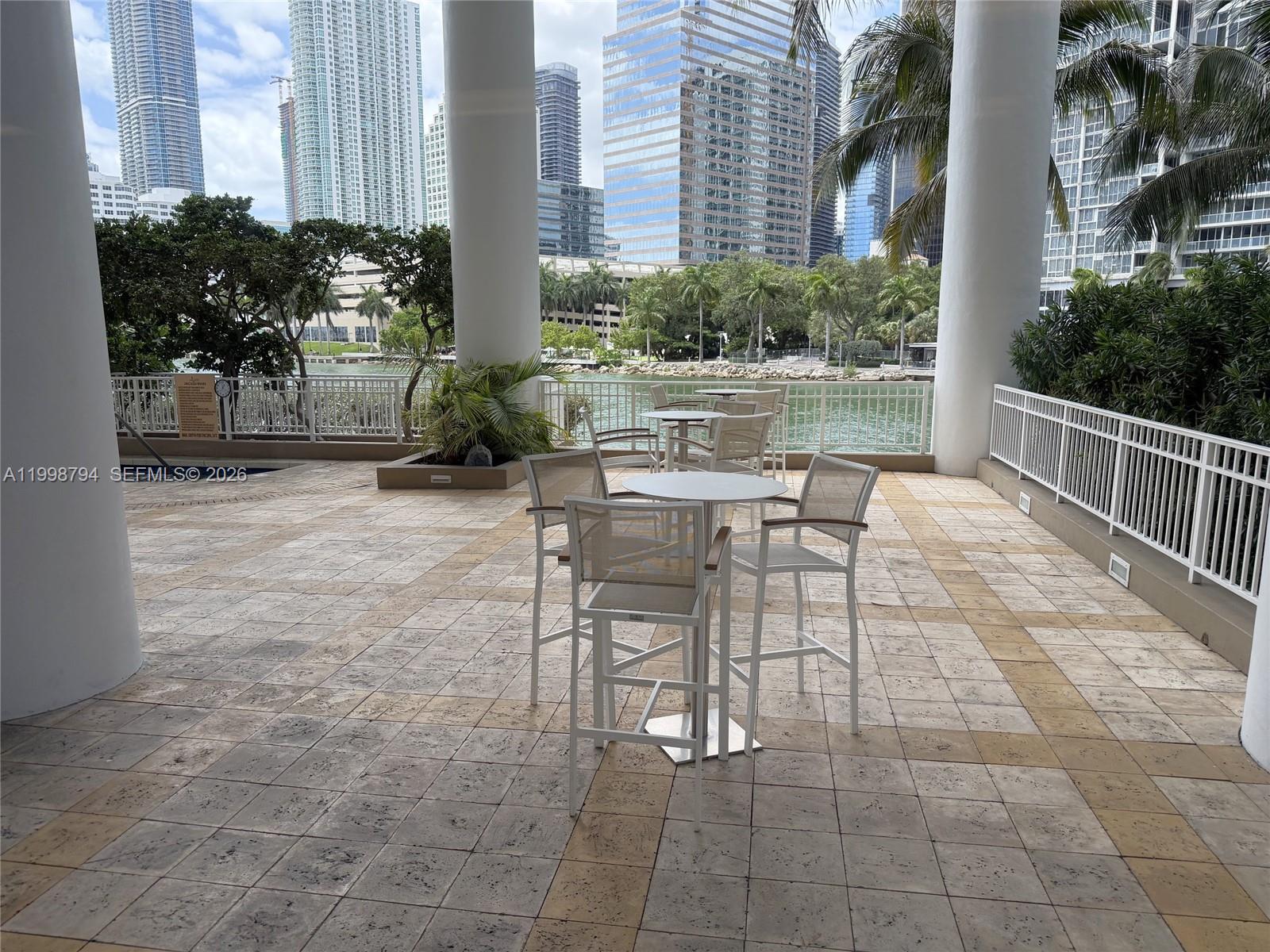 801 Brickell Key Boulevard, Unit 3207 Miami, FL 33131 - Photo 67 of 67 a view of a patio with table and chairs and potted plants
