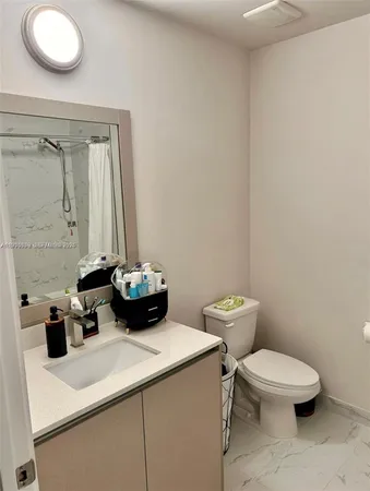 a bathroom with a sink a mirror and a toilet